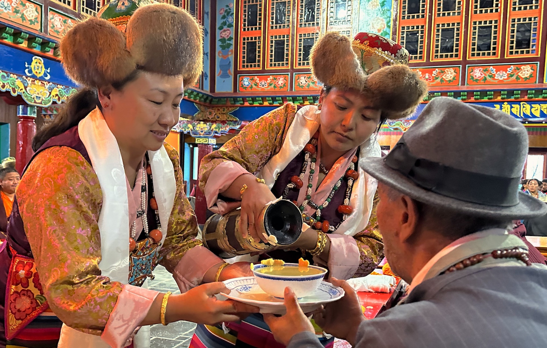 Sherpa ladies offering Chang to elder